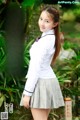 A young woman in a school uniform posing for the camera.