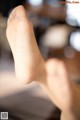 A close up of a person's foot with a blurry background.