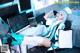 A woman sitting at a desk in front of a computer.